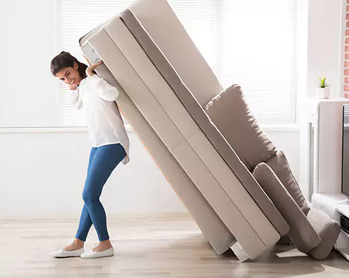 Woman moving sofa | Donald E. McNabb Flooring