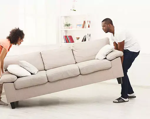 Couple moving sofa | Donald E. McNabb Flooring